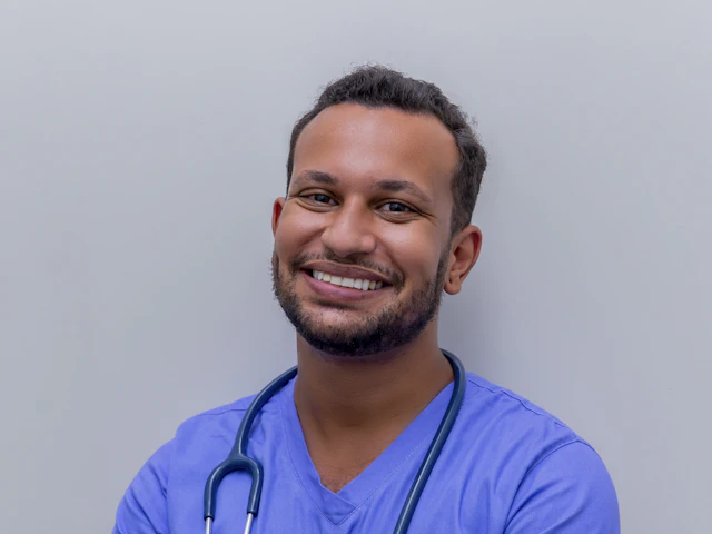 Ad creative: smiling doctor in blue scrubs