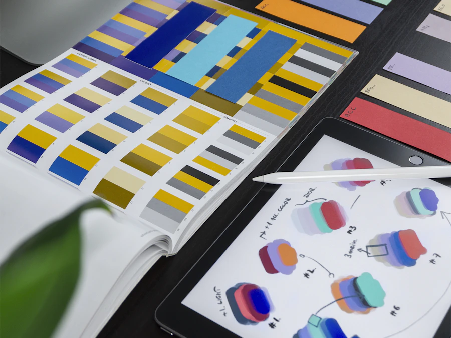 Brand identity in progress — color palettes and logo sketches on a design tablet