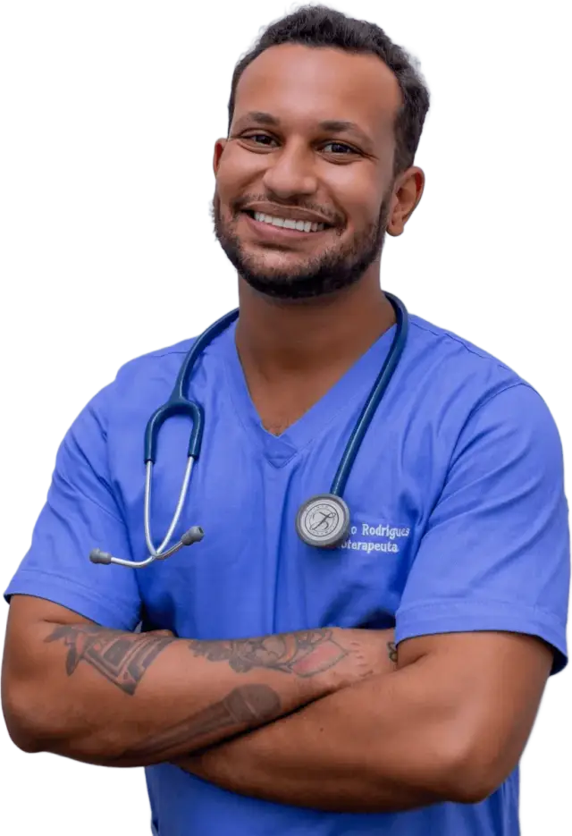 Smiling doctor in blue scrubs with arms crossed