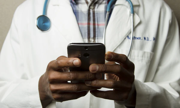 Doctor searching on a phone, not finding their own clinic